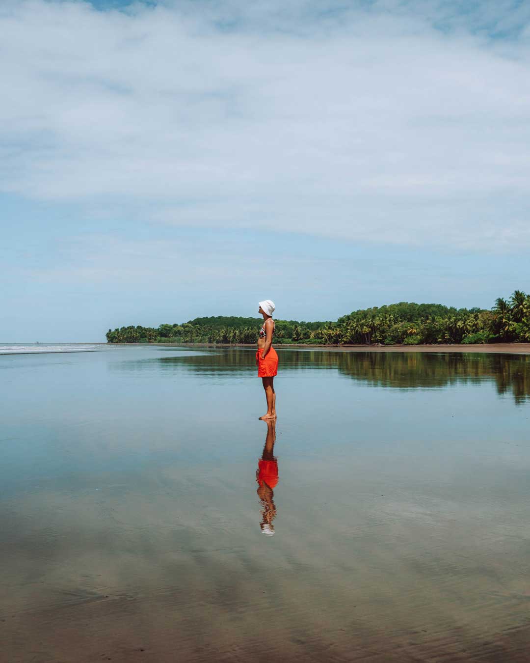 Woman standing alone on a big beach